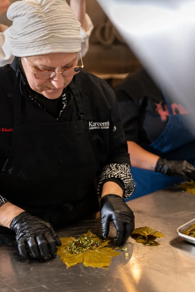 Khadija Eido, Chef Rachid's mother, filling grape leaves with herbs and rice in the Kareem's kitchen